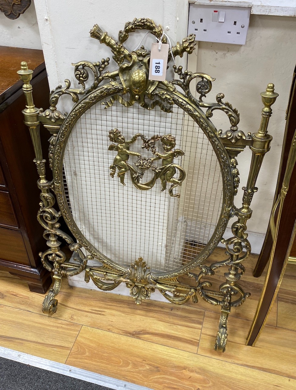 A Victorian style cast brass mesh fireguard, height 87cm.